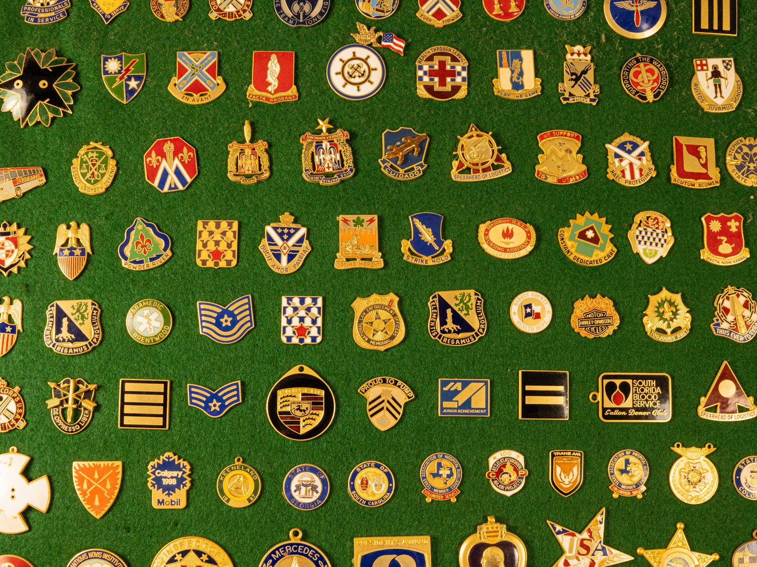 Display case of badges, pins, and insignia finished by New England Colors