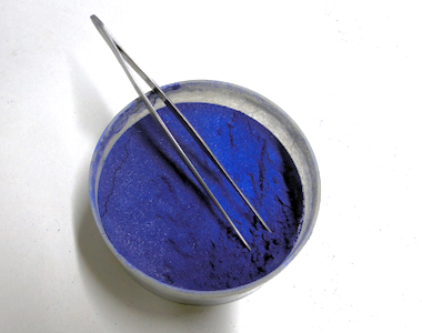Crushed enamel glass powder with tweezers